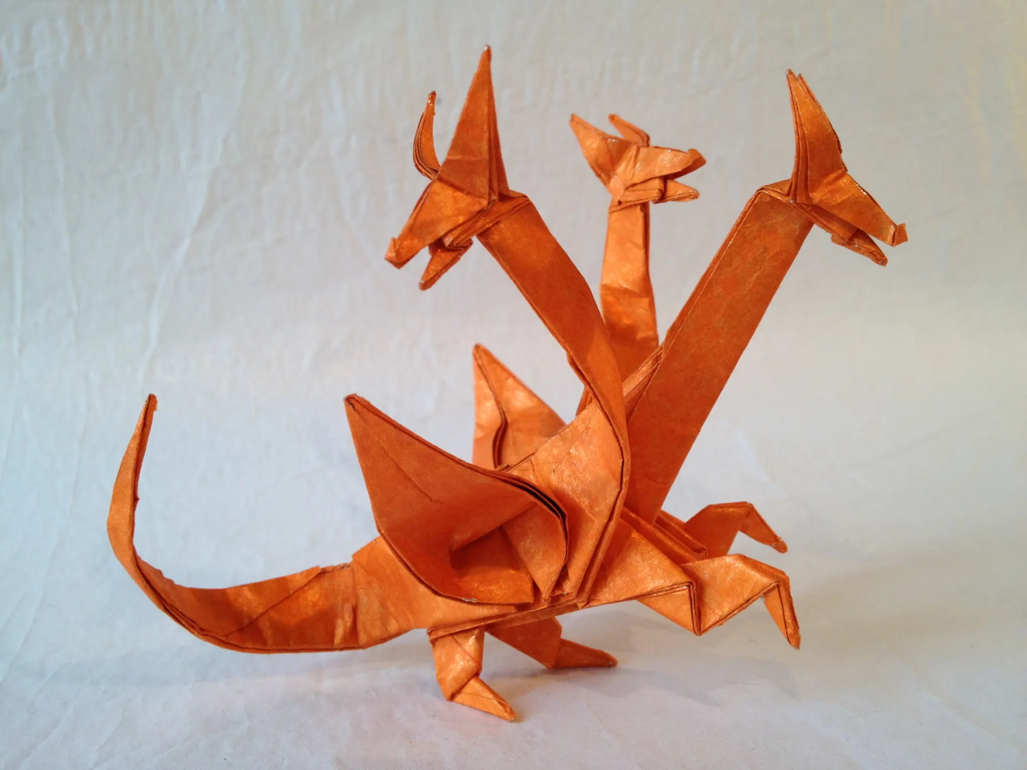 John Montroll's three-headed dragon, folded by [friesenfolding](https://friesenfolding.com/magical-creatures/origami-shoot-3-193/)